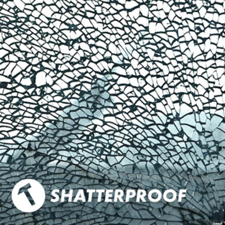 Originali Mathmos Neo lavos lempa – Nedūžtantis stiklas Suskilinėjusio stiklo tekstūra su užrašu „Shatterproof“ ir plaktuko piktograma, iliustruojanti saugią Mathmos Neo lavos lempos dangą